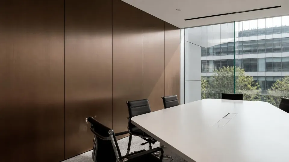 Office meeting room wall clad in bronze No.4 matte stainless steel