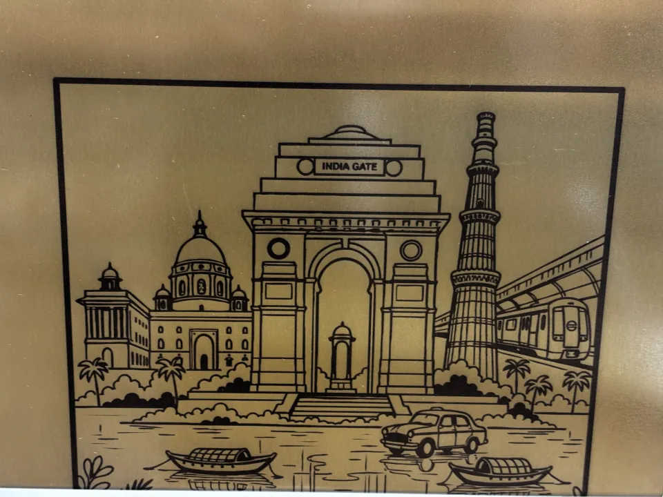 Custom artwork of India Gate and Qutub Minar on a gold stainless steel sheet