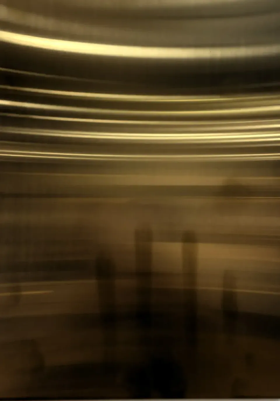 Gold PVD stainless steel sheet with a reflective brushed surface, on display