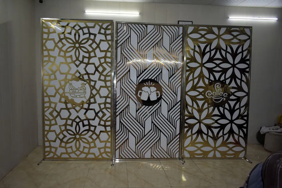 Three laser-cut partition screens in gold-tone PVD stainless steel