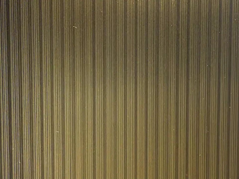 Close-up of a linear textured brass stainless steel sheet