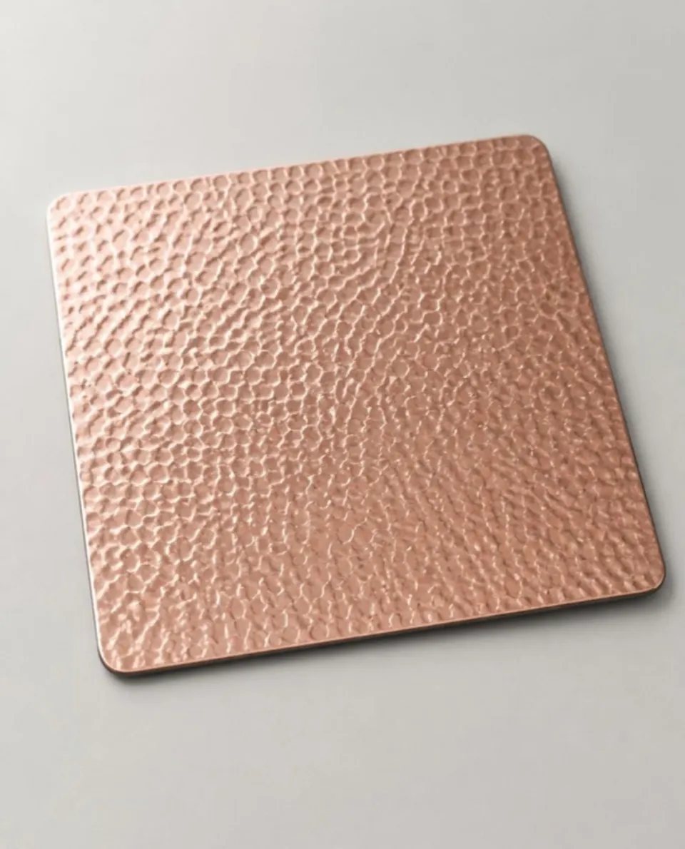 Rose gold embossed stainless steel sheet sample, raised embossed texture (AI studio visual)