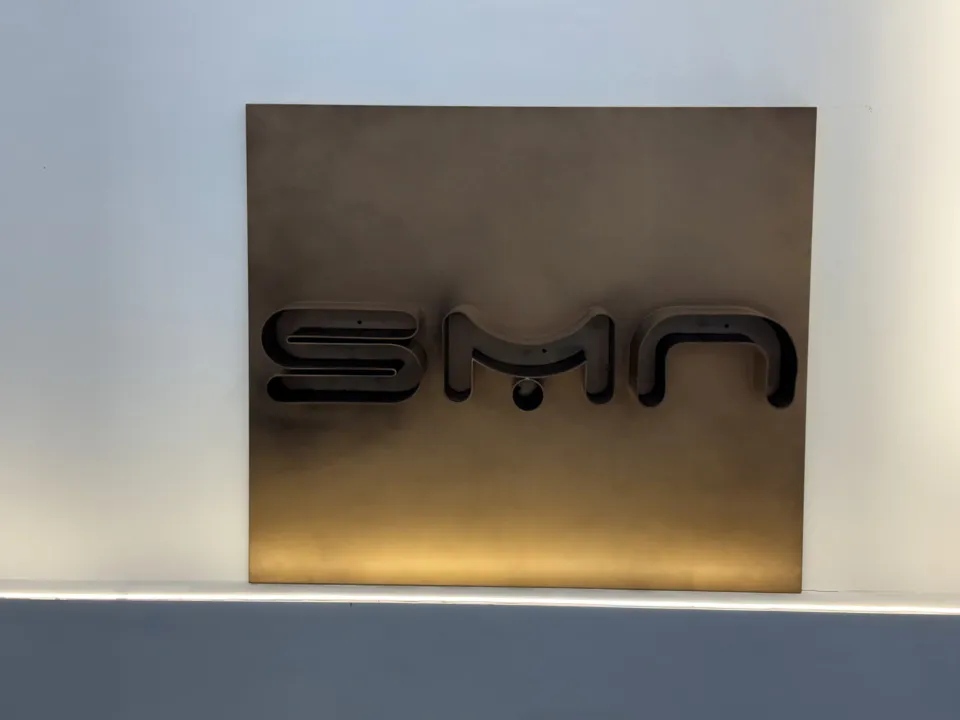 SMN logo on a bronze stainless steel panel